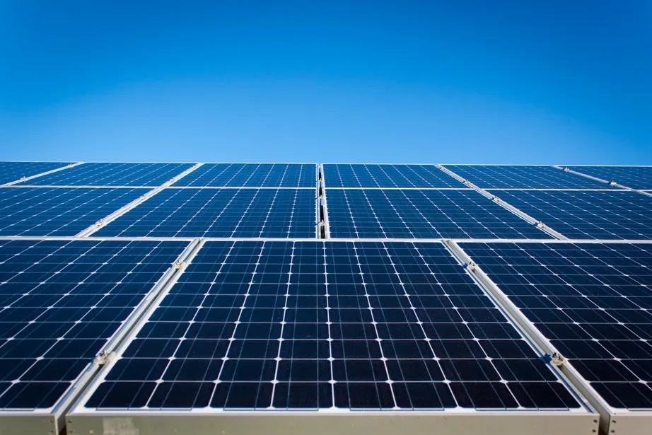 Rows of solar panels against a clear blue sky