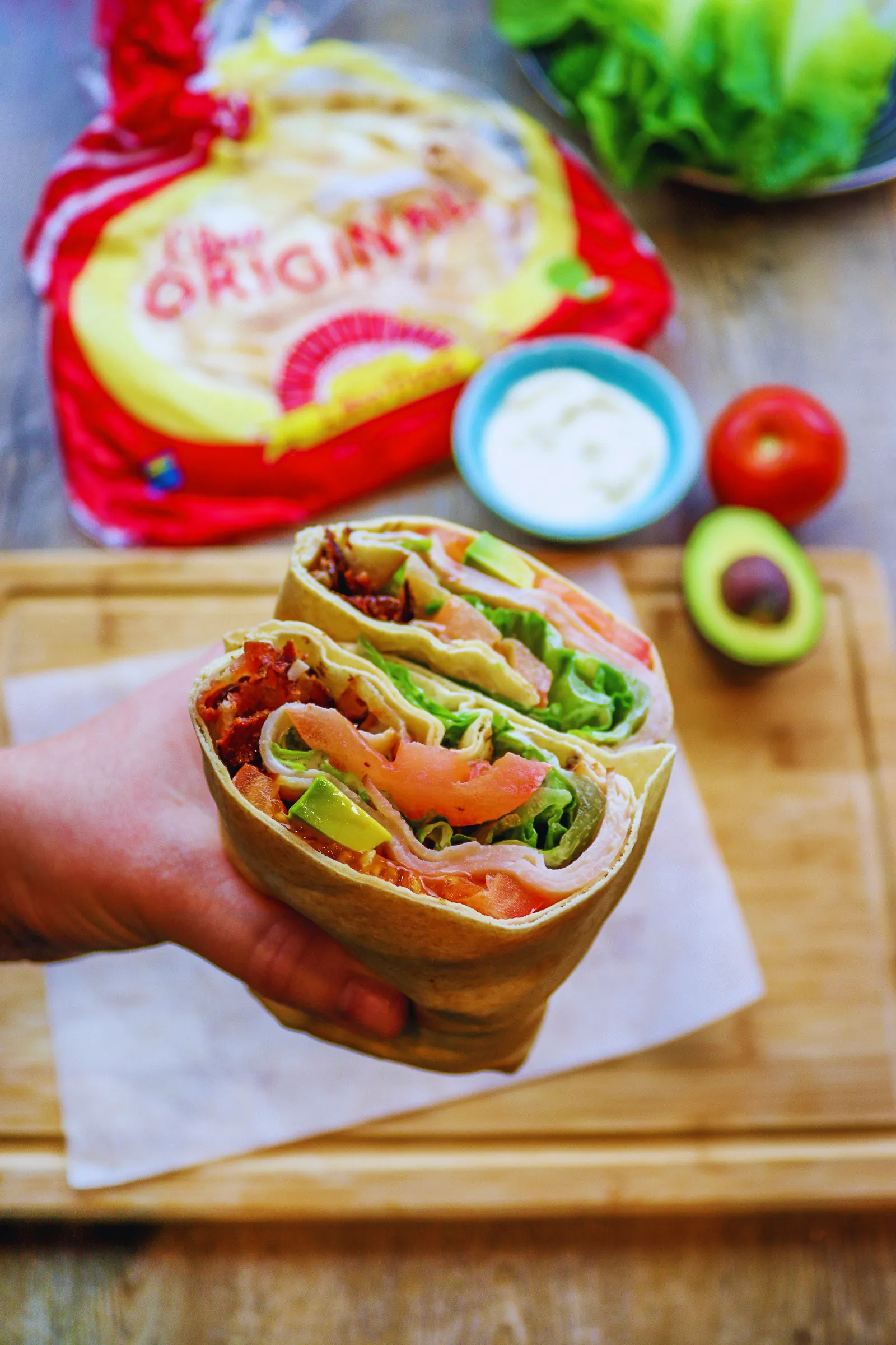 A filled Liba flatbread wrap held in one hand